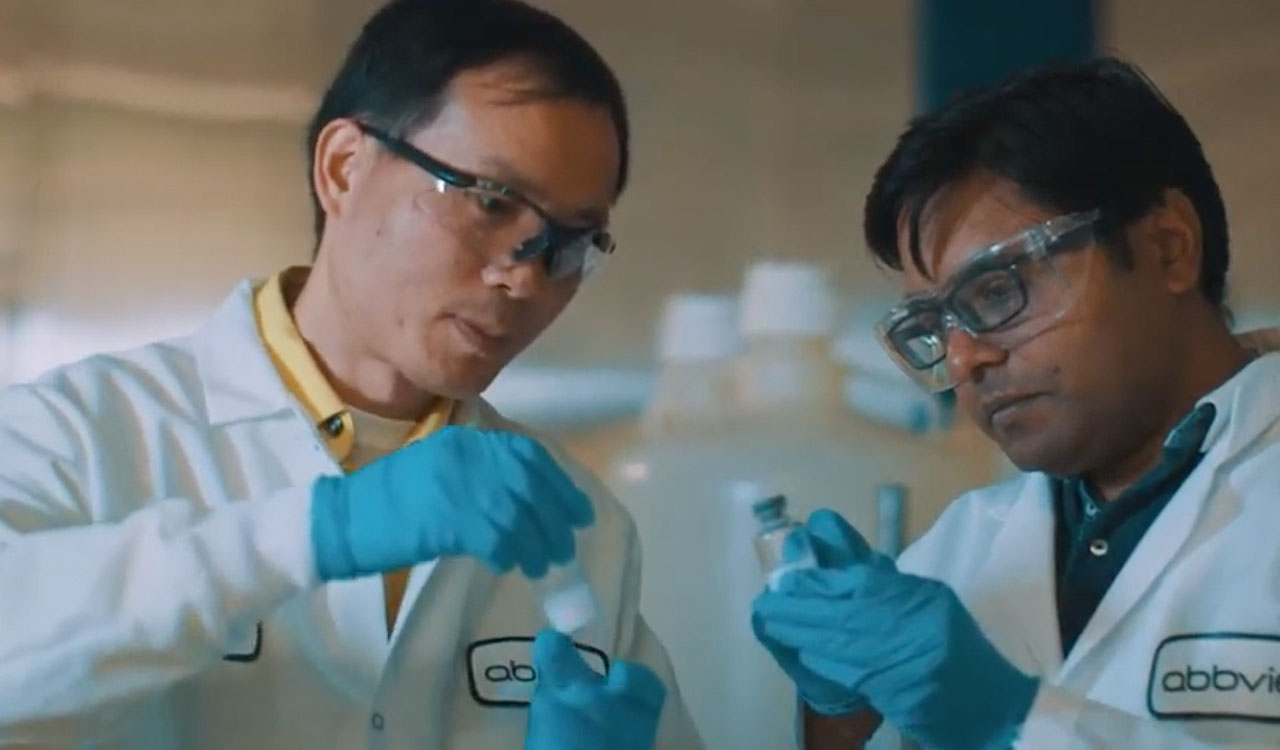 Two AbbVie doctors wearing goggles and holding vials